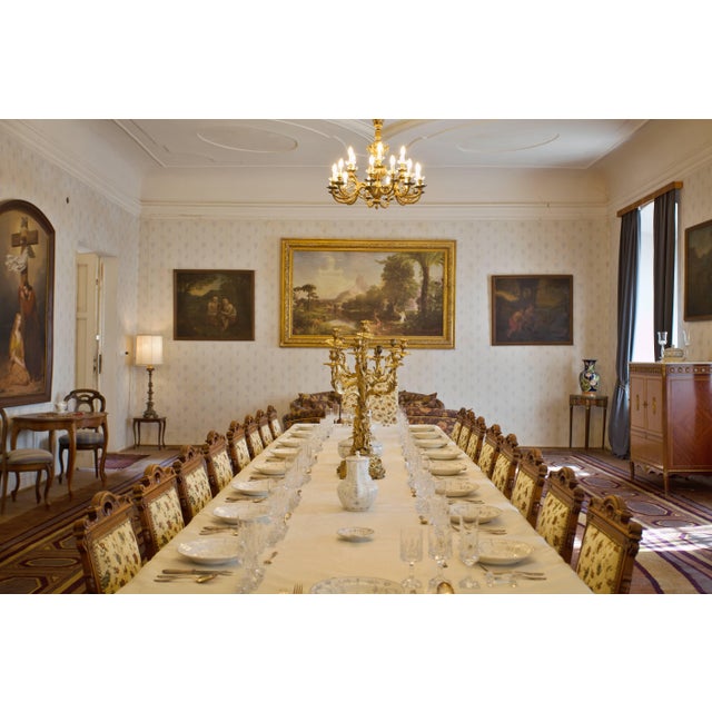 An exceptional and highly impressive set of 16 historic chairs originating from a château interior. Crafted from solid...