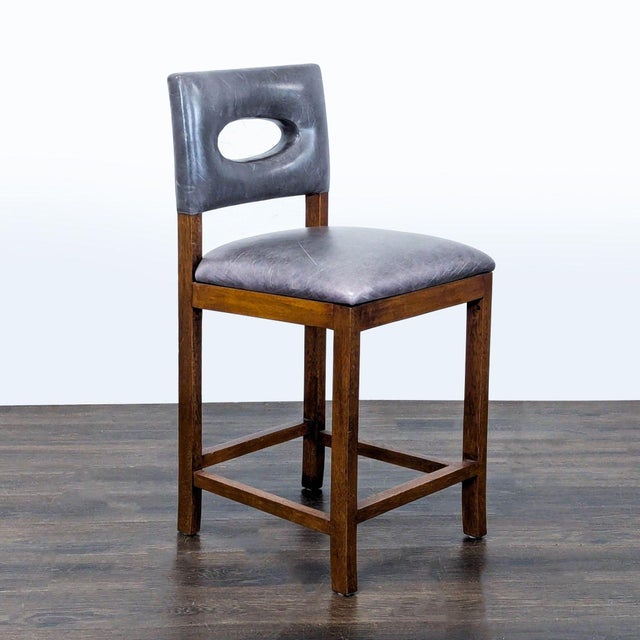 Wood stool with cut-out back. Brand: Palecek. Dimensions (in): 18W x 19D x 37H.