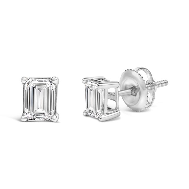 Immerse yourself in the splendor of these exquisite 14K white gold solitaire stud earrings, each cradling a 3/4 carat...