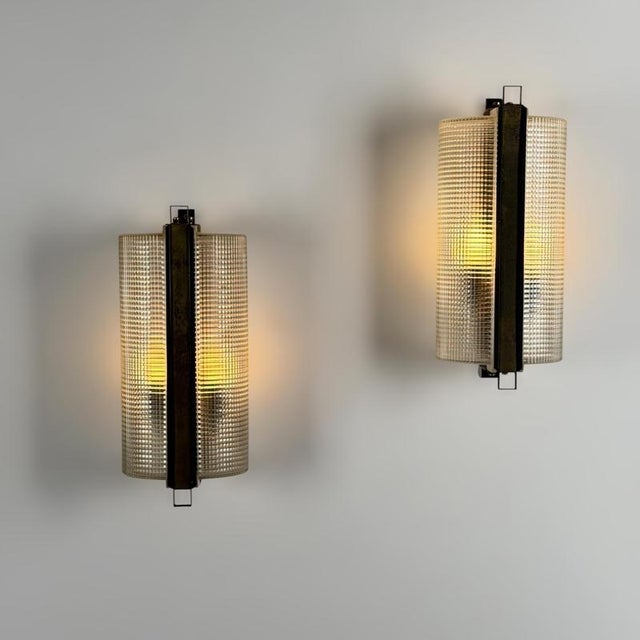 An elegant and exceptionally rare pair of wall sconces attributed to Jacques Adnet, created during the 1960s and exemplary...