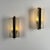 An elegant and exceptionally rare pair of wall sconces attributed to Jacques Adnet, created during the 1960s and exemplary...