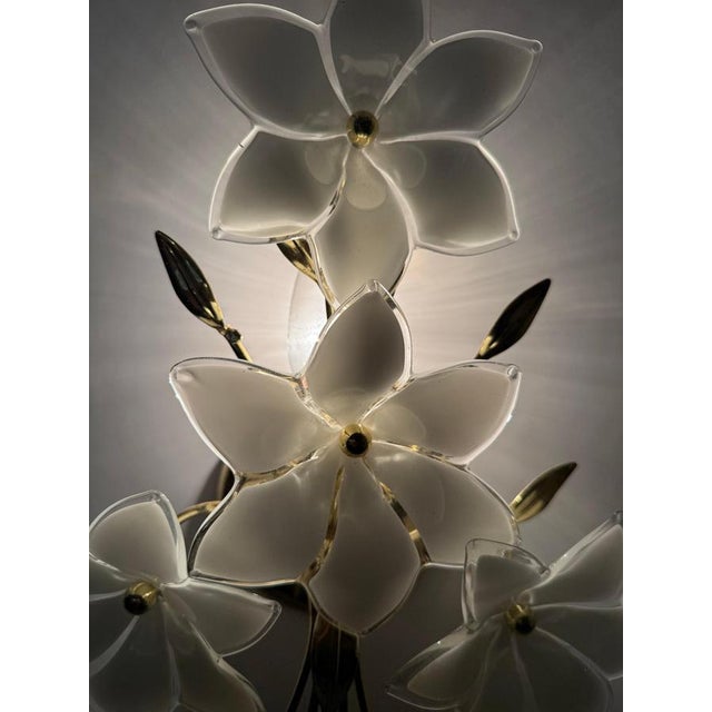 This beautiful set of two wall lights captivates with the charm of its decade. The beautiful glass blossoms were shaped by...
