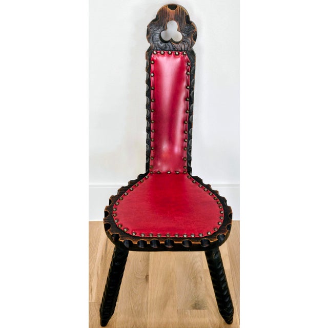 A striking vintage Spanish Brutalist-style tripod chair featuring a dramatically high back, deeply textured carved wood,...