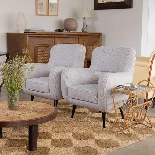 Beautiful pair of vintage Italian armchairs from the 1960's. Curvy seats newly upholstered in a blue stripe linen....
