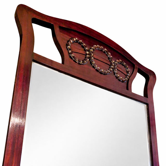 A mirror with a console in the Viennese Art Nouveau style, made of wood and veneered with mahogany. The piece is...