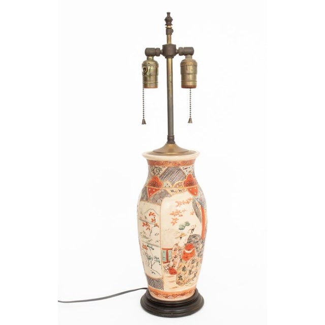 Pair of Japanese Satsuma Porcelain Vases Mounted as Lamps, figural group design with gilt accents, on ebonized bases....