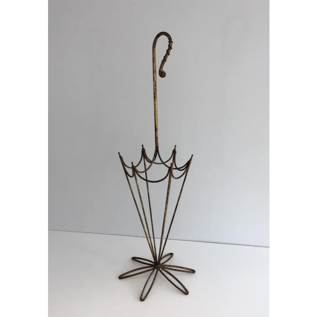 This unusual umbrella stand is made of gold gilt iron. This represents an umbrella made of gild gilt iron. This is a...