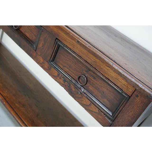This elegant side table was converted in Spain from a chestnut dining table with beautiful grain patterns. It has a warm...