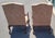 A beautiful pair of Georgian style high back armchairs. Featuring heavily carved frames tall backs upholstered in a blush...