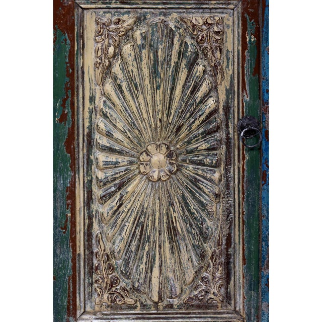 A versatile accent piece constructed from antique Indian teak architectural fragments, featuring a sunburst carved door...