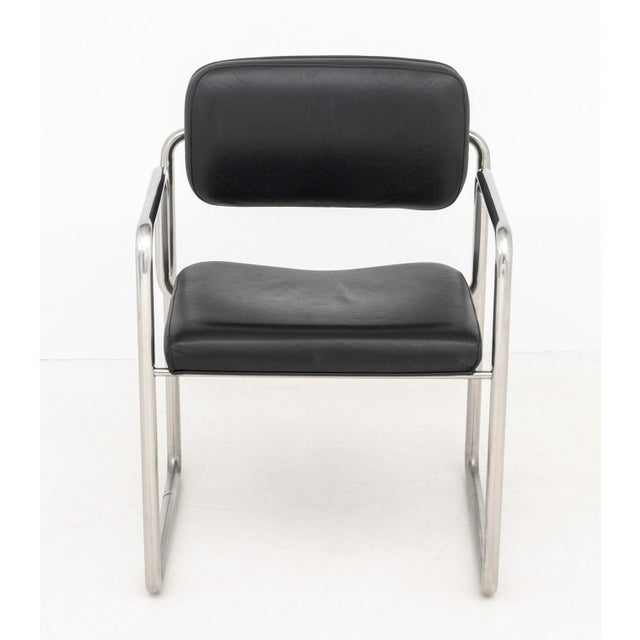Bauhaus Black Leather Upholstered Chrome Arm Chair. 30.5" H x 22" W x 21" D; seat: 17.5" H; arms: 24.25" H. Provenance:...