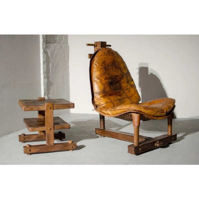 This exotic Mid-Century Brazilian patched leather lounge chair with table is extreme in its design and exhibits tribal...