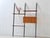 An elegant telescopic wall shelf from the 1960s with a delicate construction and timeless mid-century aesthetic. The...