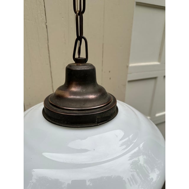 Old Lights On is pleased to offer this vintage dark brass hanging fixture with vintage white school house globe. It is...