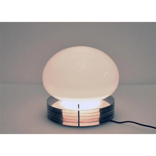 Table lamp produced by Tronconi in the 1970s. Base composed of steel discs with blown glass diffuser. In excellent...