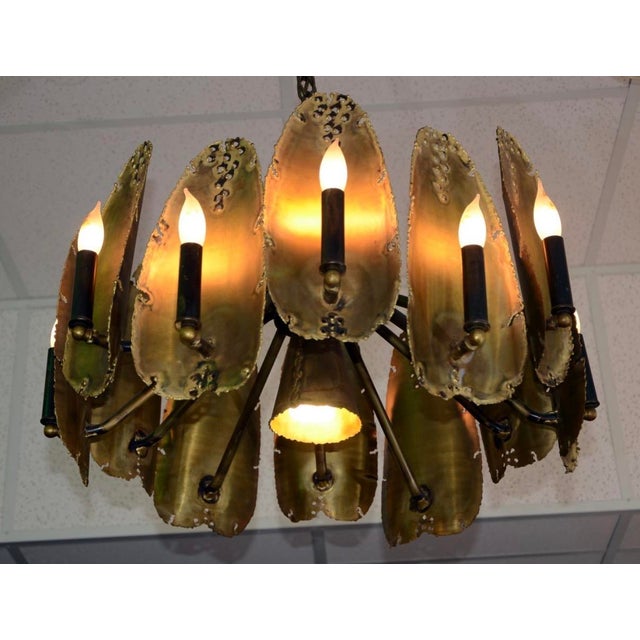 Striking Mid-Century Modern Brutalist chandelier designed by celebrated metal sculptor Tom Greene for the Feldman Lighting...