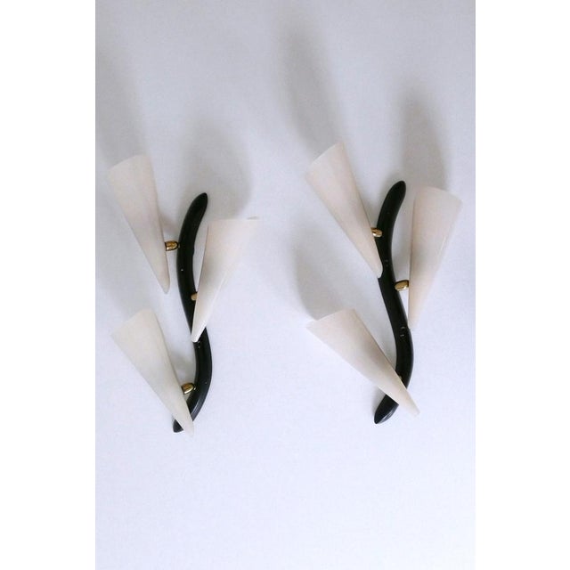 Set of two extremely rare, elegant and highly decorative mid-century modern three-flamed sconces or wall fixtures....