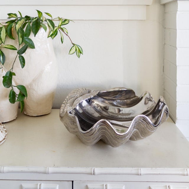 These iconic Arthur Court giant clam shell bowls feature a tactile, wavy texture, deep scalloped edges, and shiny...