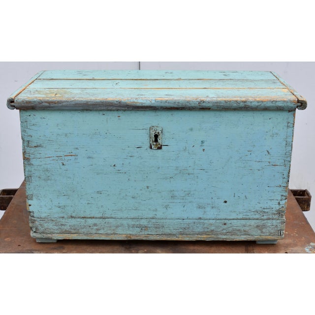 At some time in its long life somebody decided to paint this trunk a nice powder blue. From the wear on that coat of...