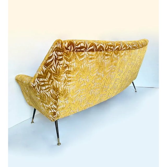 Unique 1970s vintage sofa with a linear and light shape, completely reupholstered in premium ochre viscose fabric with an...