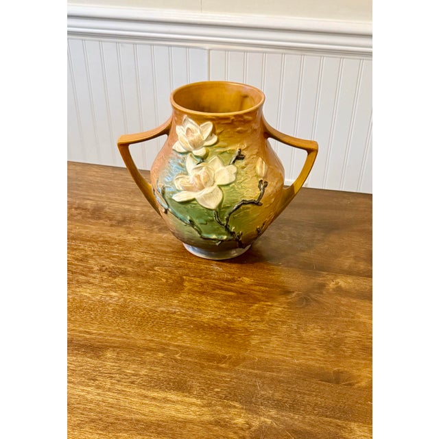 This vase exemplifies American art pottery known for its decorative qualities and floral theme. This vase has a classic...