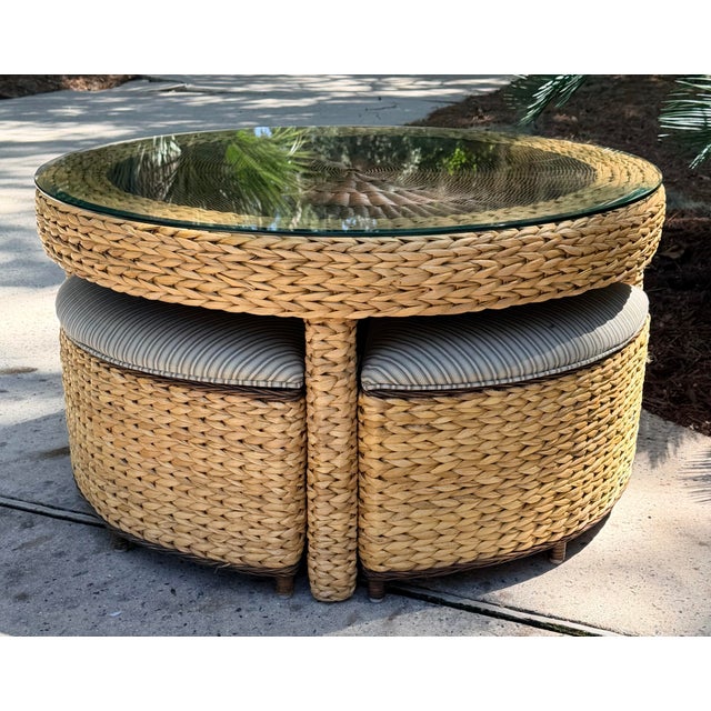 Round woven wicker coffee/game table set with matching nesting stools or wedge ottomans in a blue stripe performance...