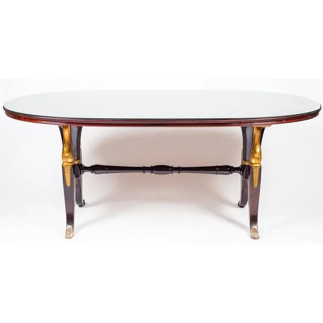 Extraordinary massive mahogany table in the style of Paolo Buffa. Decorations and finishes in gold. Glass shelf.