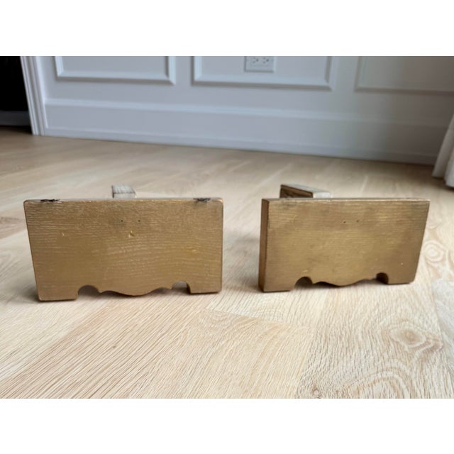 Pair Art Deco Hollywood Regency carved and gilded wood wall brackets or display shelves. Designed as decorative wall...