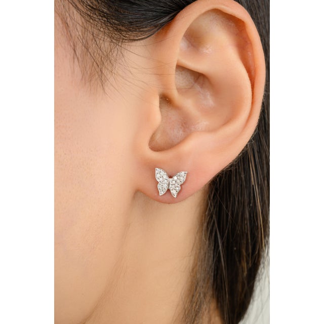 Crafted in 18K white gold, these beautiful butterfly design stud earrings radiate elegance and charm. Delicately adorned...