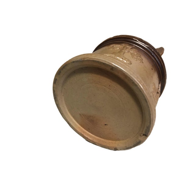 Doulton stoneware hunting lidded ware pot. This Doulton Lambeth stoneware hunting lidded ware jar features four sprigged...