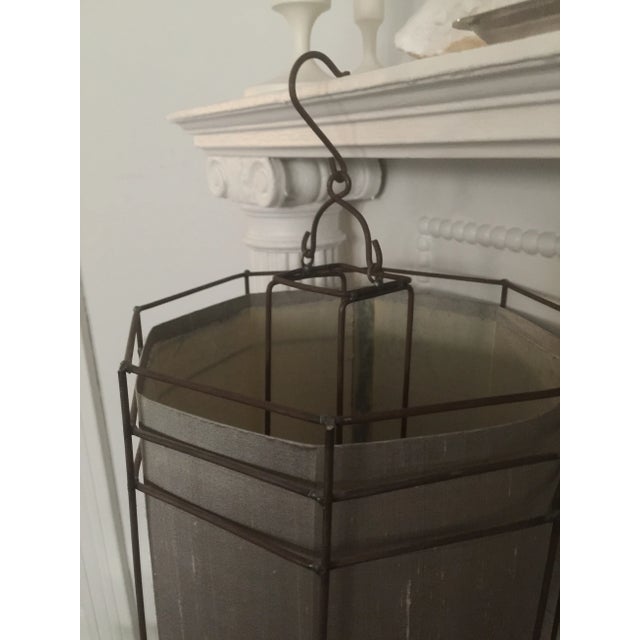 This modern octagonal shaped lantern has a Zen-chic look. The handmade antiqued metal frame stands straight up from top to...