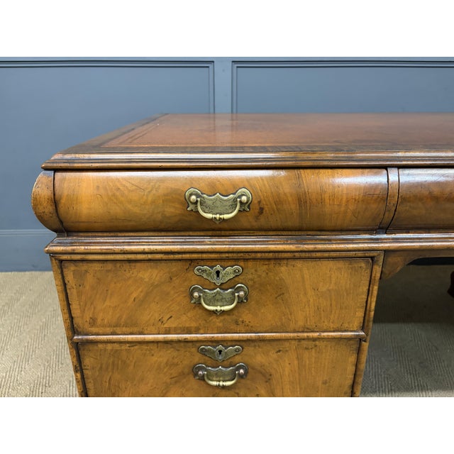 A splendid burr walnut partners pedestal desk in the queen anne style. Dating to the early 20th century and manufactured...