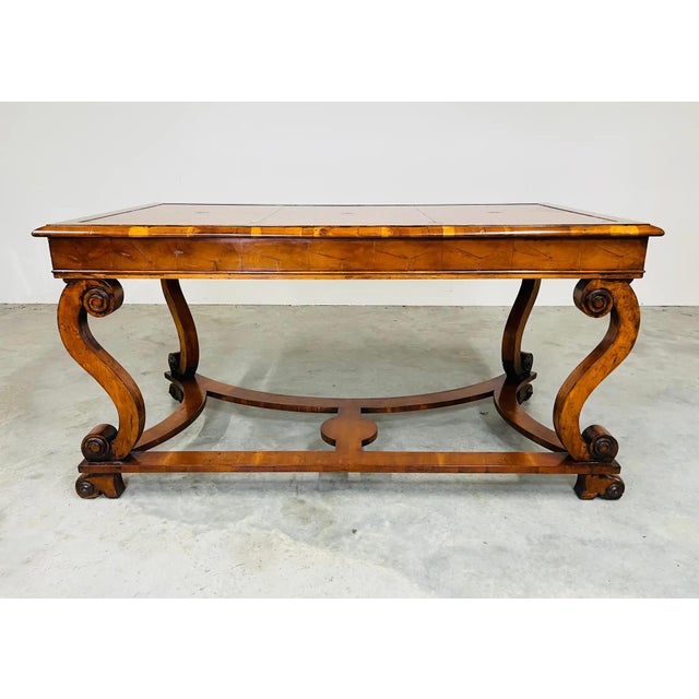 William & Mary style library desk having hand colored English hide top with gilt tooling resting on hand carved “S”...