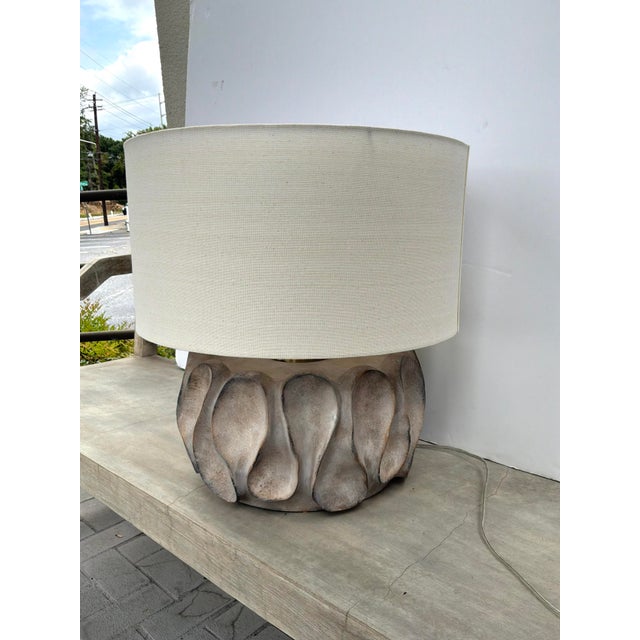 Stylish Currey & Co Weststrand Lamp. Sculptural distresed finish body with large off white linen shade. Gold accents....