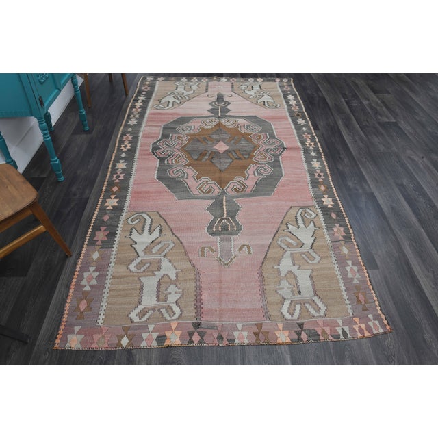 Vintage Hand-Knotted area rug is a semi-antique vintage area rug. The '70s Eastern region of Anatolia's unique rug is...