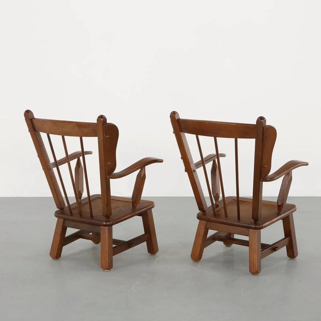 This exceptional pair of 1950s modernist Windsor-style armchairs, designed in the compelling manner of Dutch master Herman...