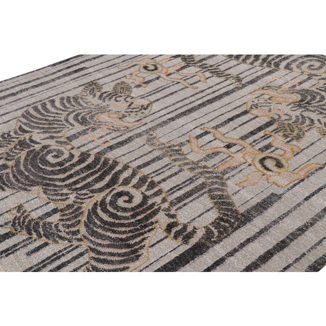 Hand-knotted in wool, this 8x10 modern tiger pictorial rug is a bold addition to the Rug & Kilim exclusive Tiger line. On...