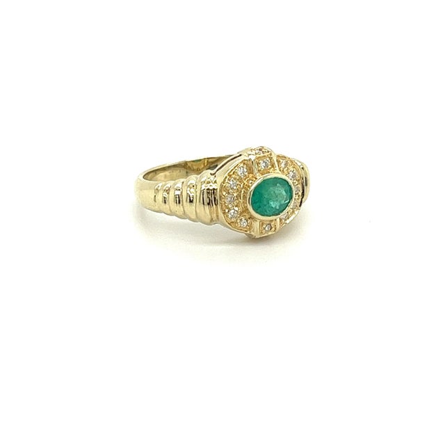 18k solid yellow gold bezel set natural emerald and diamond ring shank. Featuring a ribbed textured ring shank with a...