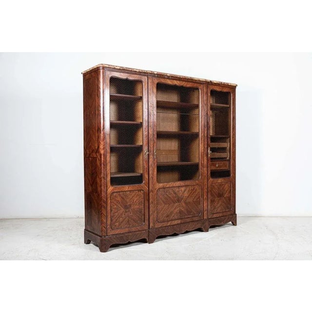 Antique circa 1890 19th c french walnut armoire / bookcase with wired grill doors and book matched walnut veneer with...
