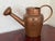 This French Country copper watering can has a long spout fitted with a sprinkler spout and a half cover over the top. The...