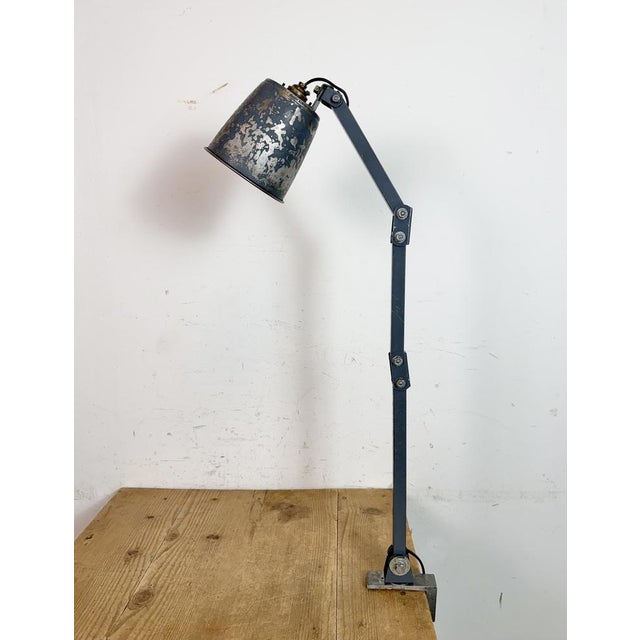 This vintage Industrial adjustable table lamp was produced by Memlite in United Kingdom during the 1960s. The lamp has a...