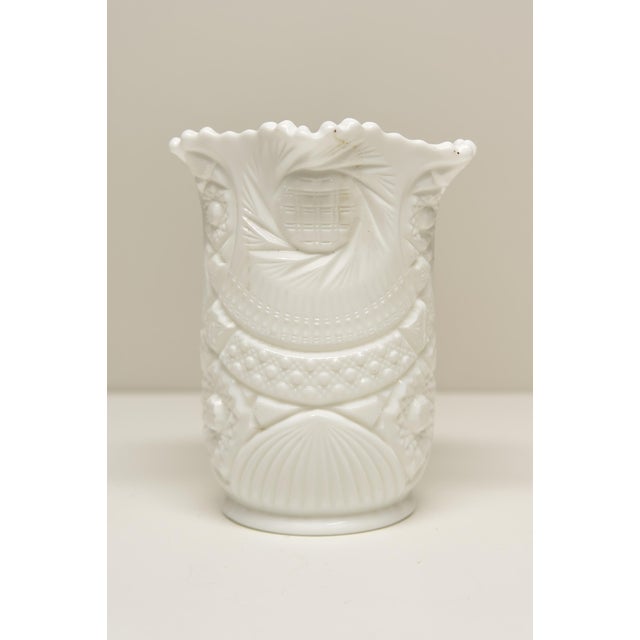 A pressed milk glass celery vase produced by Kemple Glassworks circa 1950s, featuring the distinctive Sunburst—also known...