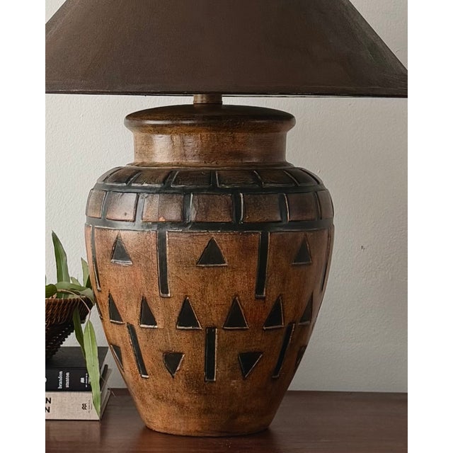 A sculptural vintage table lamp featuring a substantial earthenware body with a warm, mottled terracotta-brown finish and...