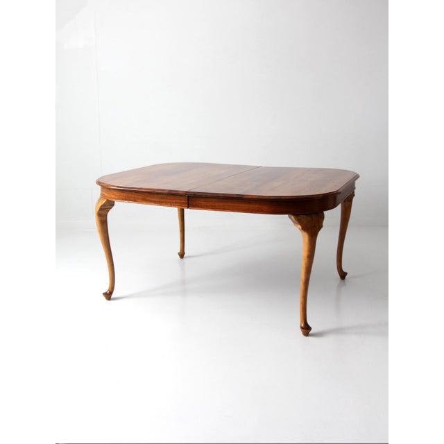 Early 20th century Queen Anne Revival dining table featuring sculptural cabriole legs and a beautifully aged wood surface....