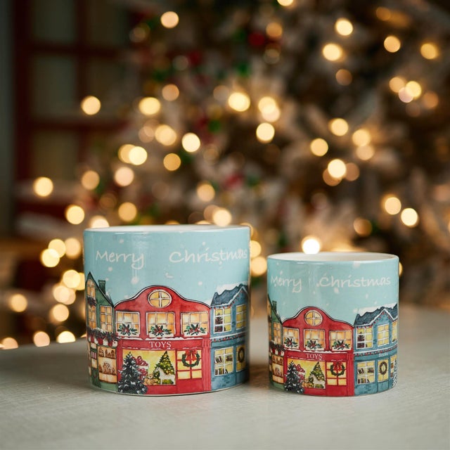 Add a charming holiday touch to your seasonal decor with this set of two Merry Christmas Village Planters. Designed in...