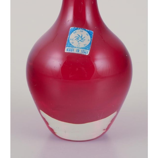 Murano, Italy. Art glass vase in clear and red glass. Approximately 1960s. Label. Perfect condition. Dimensions: H 21.5 cm...