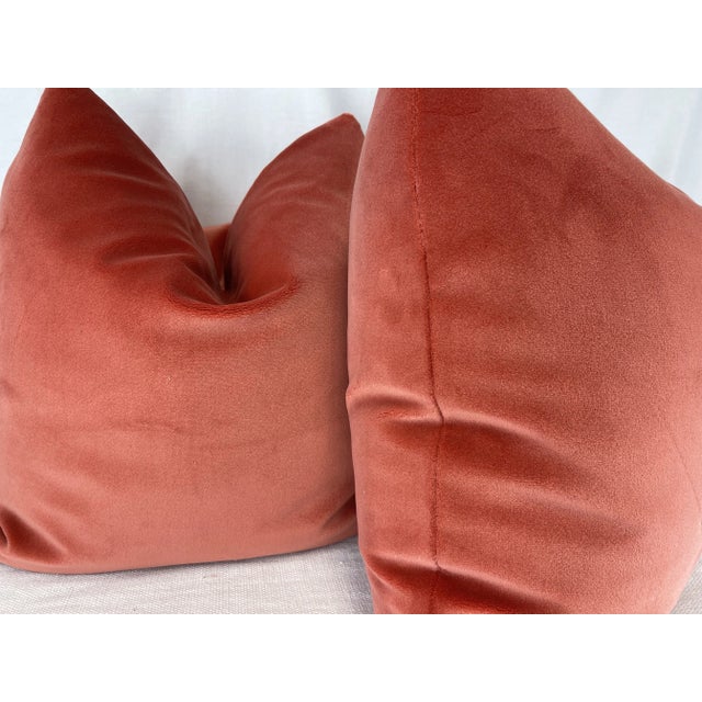 Custom pair of 22" pillows covered in Scalamandre "Torino Velvet" in color coral. These pillows have tapered corners to...