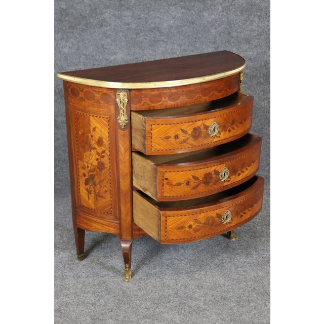There are commodes and then there are demilune commodes. This is a gorgeous rosewood and walnut bronze mounted commode...