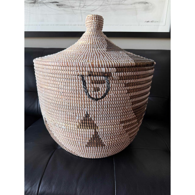 Large handwoven lidded basket vessel with a beautifully graphic, irregular pattern in natural wheat and charcoal tones....