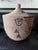 Large handwoven lidded basket vessel with a beautifully graphic, irregular pattern in natural wheat and charcoal tones....